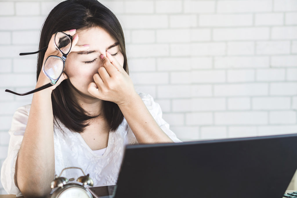 woman has dry eye pain working at computer